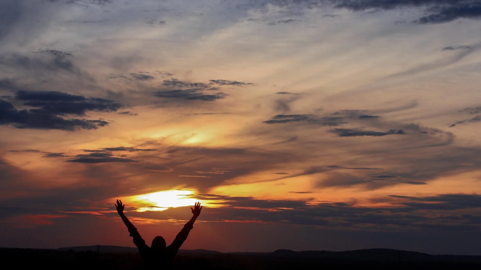 Featured image for gratitude quotes showing open arm appreciating a sunset