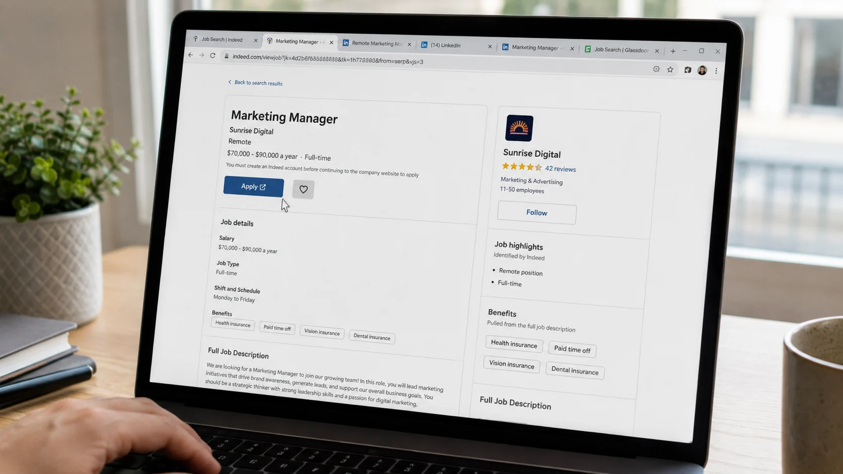 laptop screen showing job listing page, cursor near apply button, unclicked